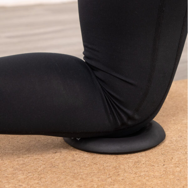 Lifestyle of the black yoga jelly support pad in use with a knee