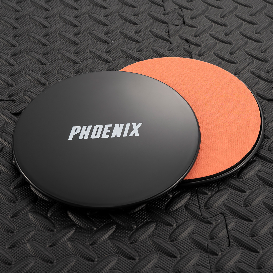 Black and Orange Exercise Sliders on gym flooring showing dual sided design