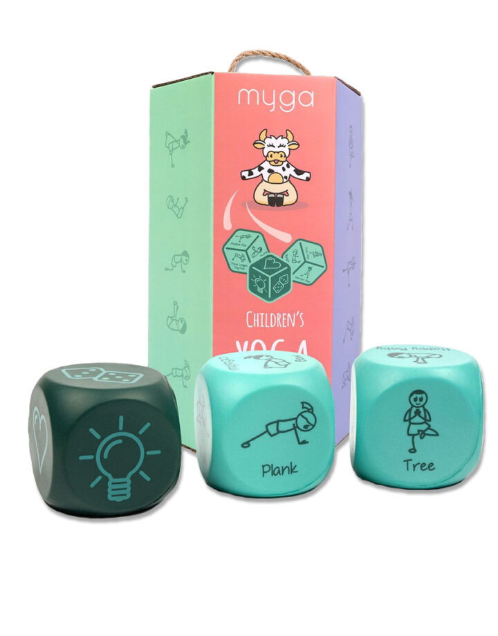 The three children's yoga dice is position infront of the packaging