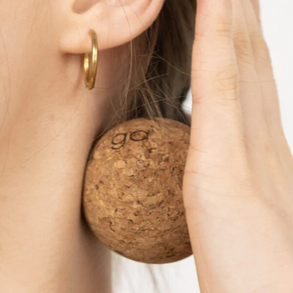 5cm cork massage ball, being used on the neck with the palm of hand