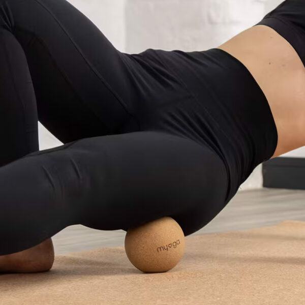 10cm cork massage ball being used on the upper leg