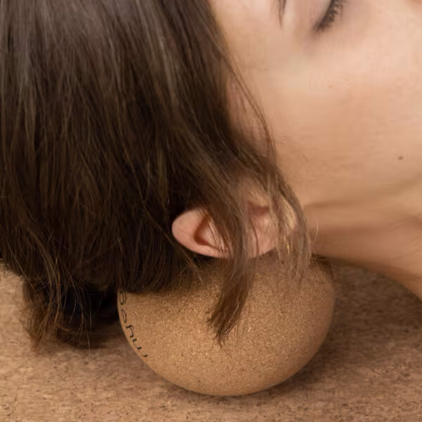 10cm cork massage ball being used on the neck