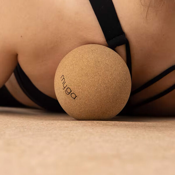 10cm cork massage ball being used on the shoulder
