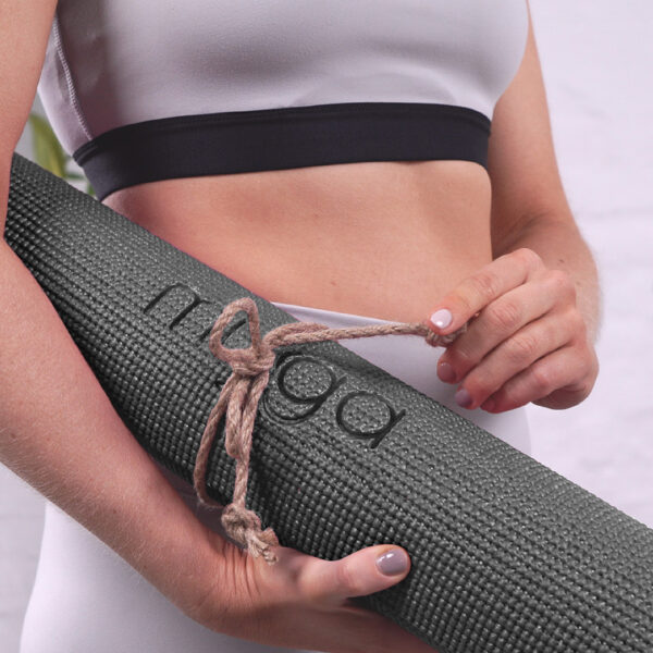 Myga logo being proudly presented on the black yoga mat