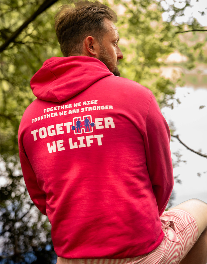 Pink together we lift hoodie being worn with full slogan on the back 