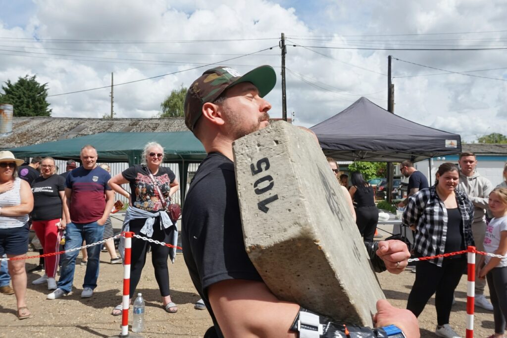 Strongman competition at Buds Fitness showing the intensity that led to adding yoga recovery work