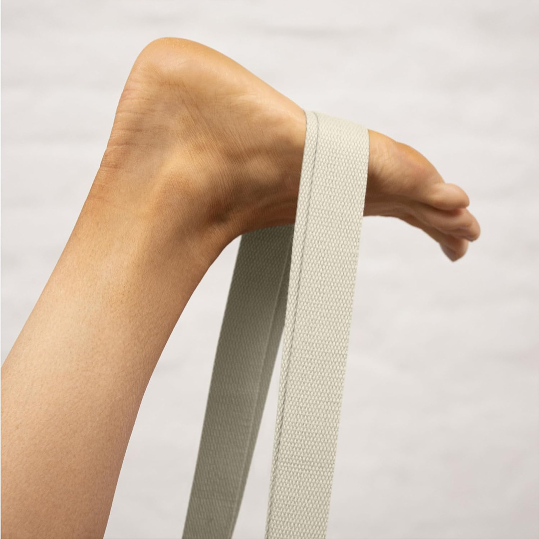 Sand coloured yoga strap around the foot