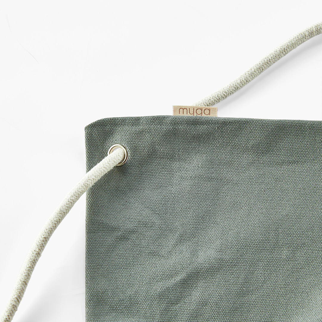 Cotton fabric and carry cord detail on yoga mat bag