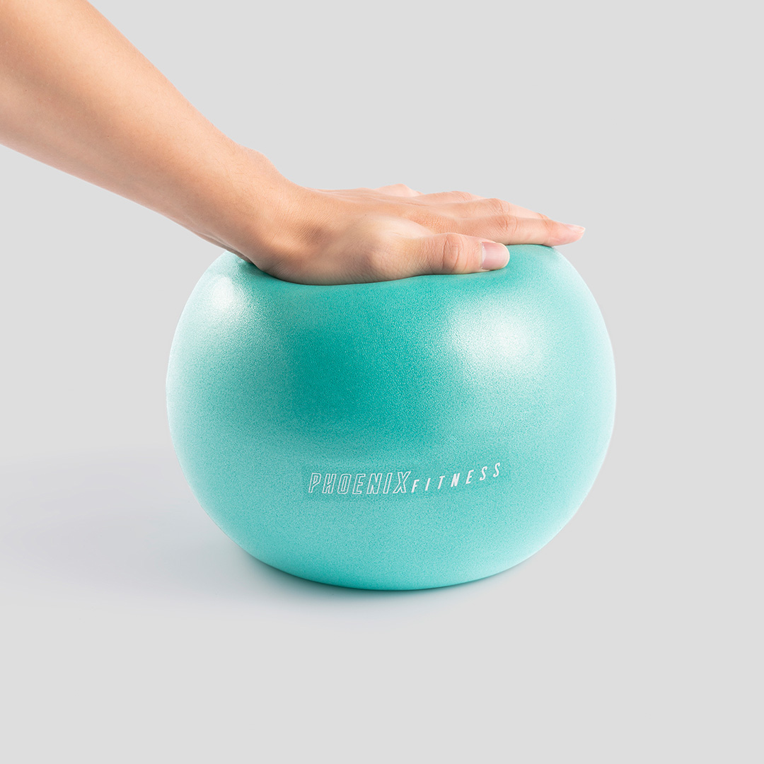 Aqua green Phoenix Fitness Pilates ball being pressed to show adjustable firmness
